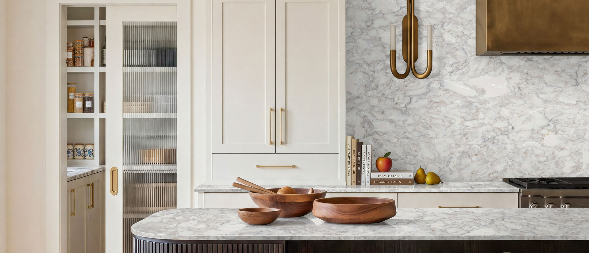 Kitchen with Calacatta Ocellio quartz countertops and island